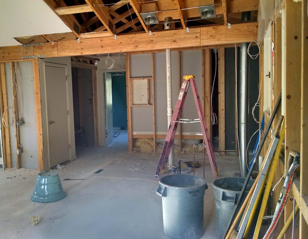 Structural engineering design - load bearing wall removal. A photo of a new structural beam replacing a prior load bearing wall that was removed.